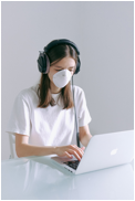 User Taking Precautions by Wearing a Face Mask & Headphone Covers